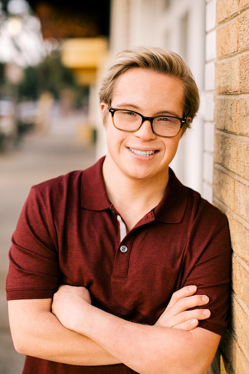 Professional headshot of Cole in a burgundy polo.
