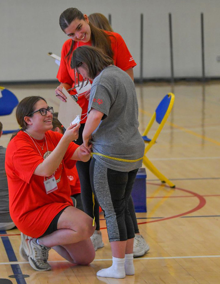 young girl being measured for a fitness test