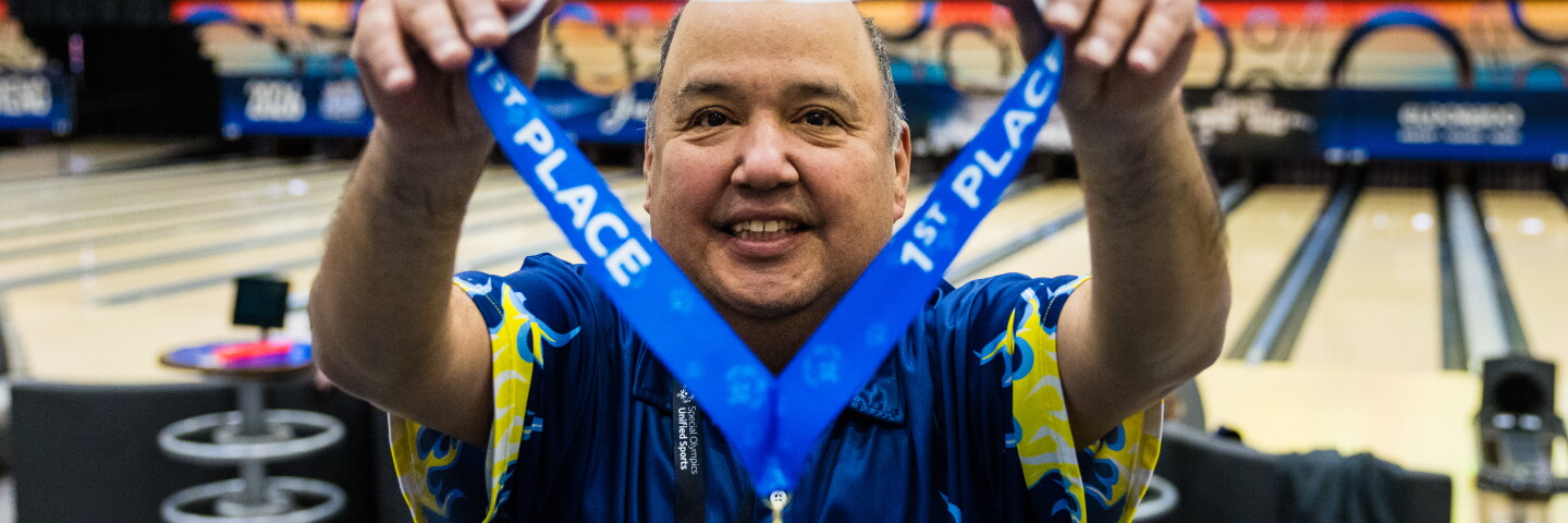 Athlete showing off medal. 
