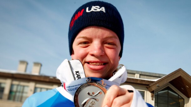 Daina Shilts holding up her silver medal at the 2013 Special Olympics. 