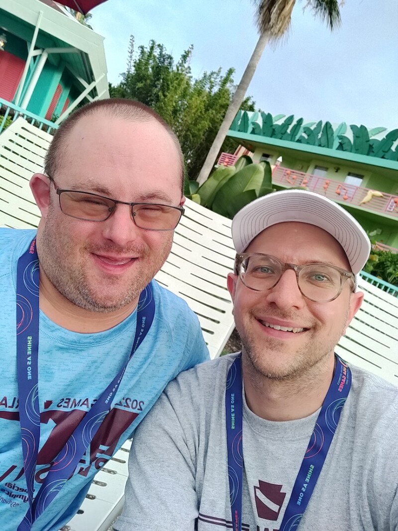 A Special Olympics athlete and volunteer smile for the camera. 