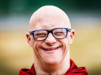 Portrait photo of man sharing an ear-to-ear smile
