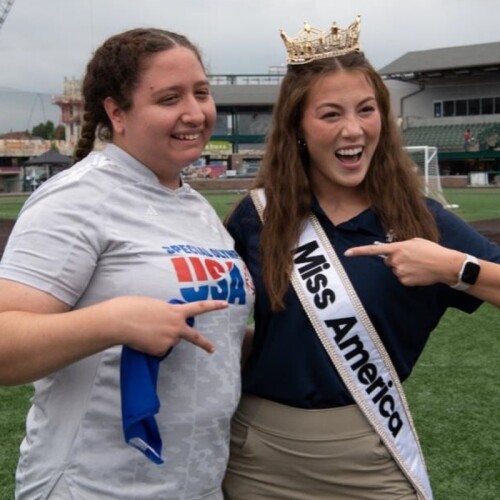 Emma Broyles standing with an athlete. 