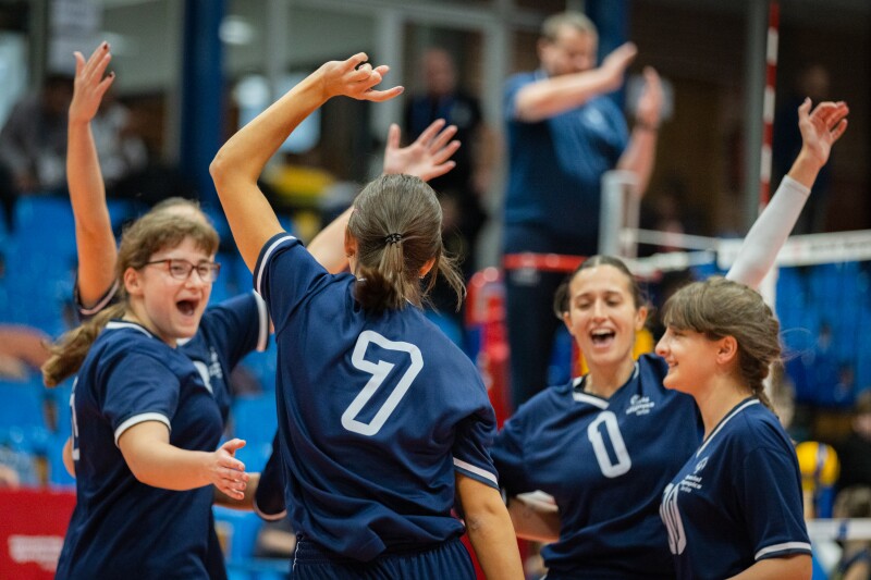 Marija Kostić and her teammates wave their hands in the air joyfully