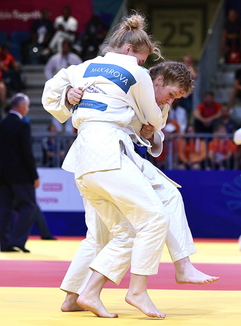 Two athletes in close contact on judo mat