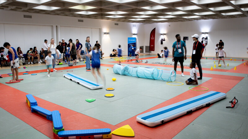 A young athletes event showcasing different activities in a gymnasium setting