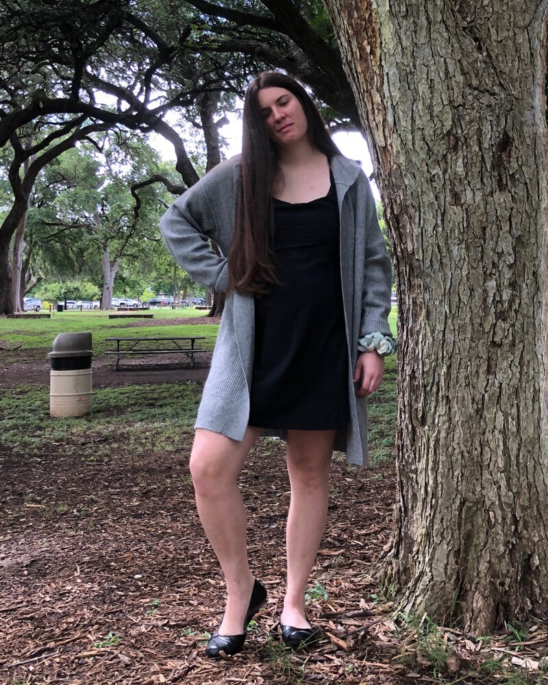 Kaylah Hankins outside standing next to a tree.