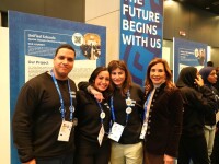 A group of four people standing together. 