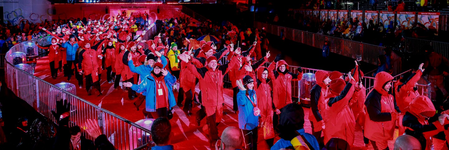 Athletes walking into a stadium during the opening of a Special Olympics World Games.