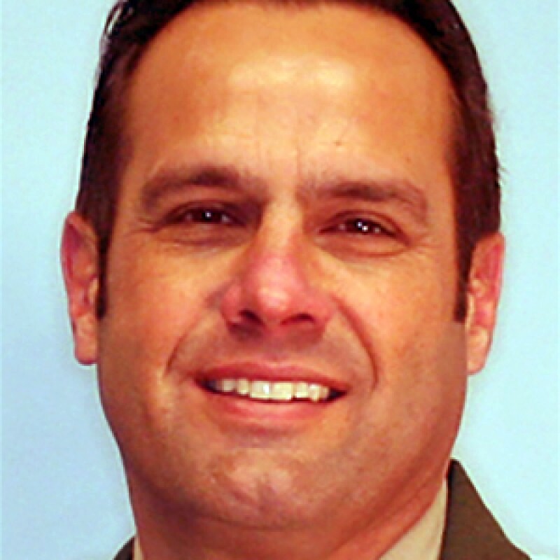 Ian Parkinson smiling in a portrait photo.