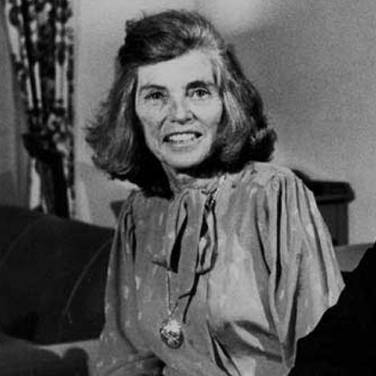 Eunice Kennedy Shriver smiling in a black and white photo