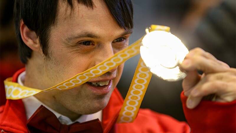 Jonathan Clutterbuck holding up his medal.