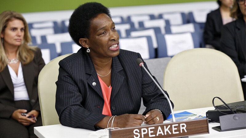 Loretta Claiborne sitting at a table speaking.