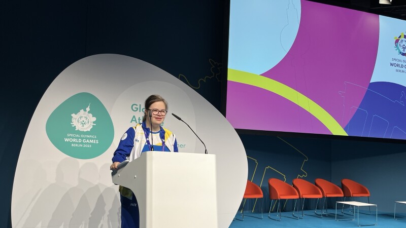 Athlete standing at a podium speaking. 