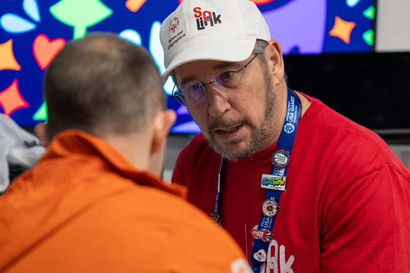 a man speaking to an athlete. 
