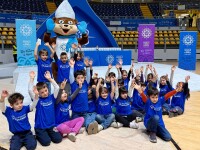 Young athletes in a gymnasium with the Special Olympics World Witner Games Turin 2025 mascot. 