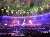Packed stadium with fireworks in the background