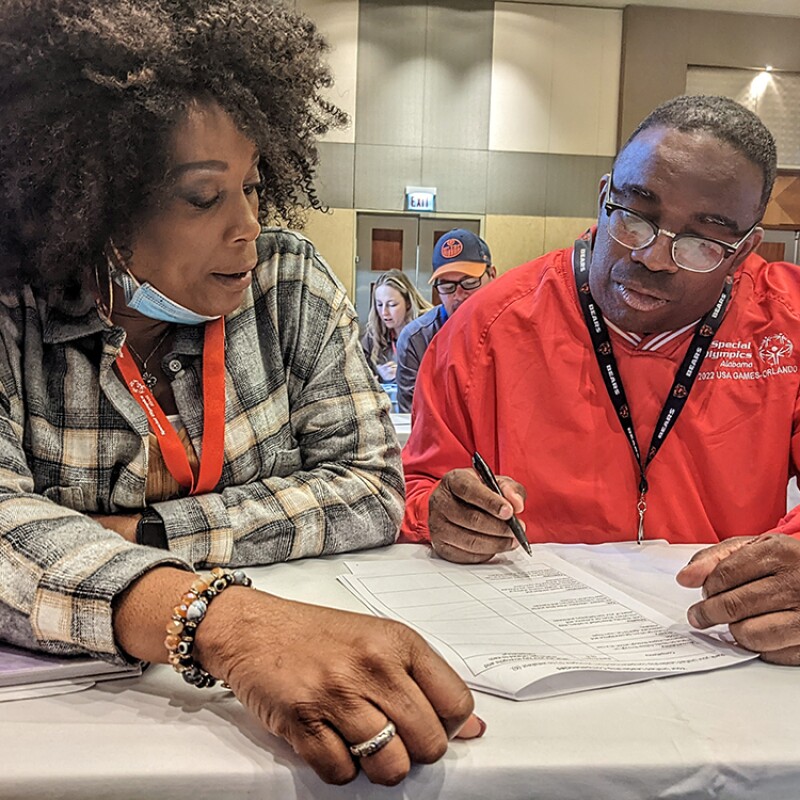 A woman looking over a document with a man. 