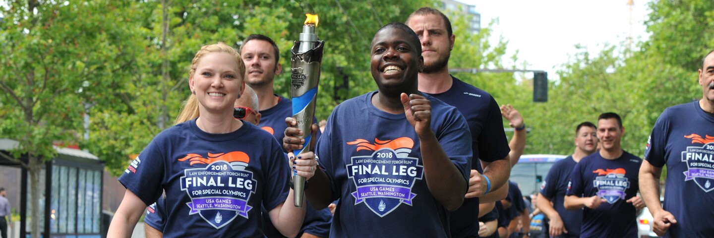 Group of runners running and holding the flame of hope.