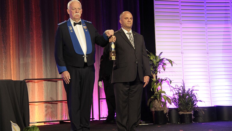 Kevin Brown carries the Flame of Hope with LETR Chairman Scott Whyte.