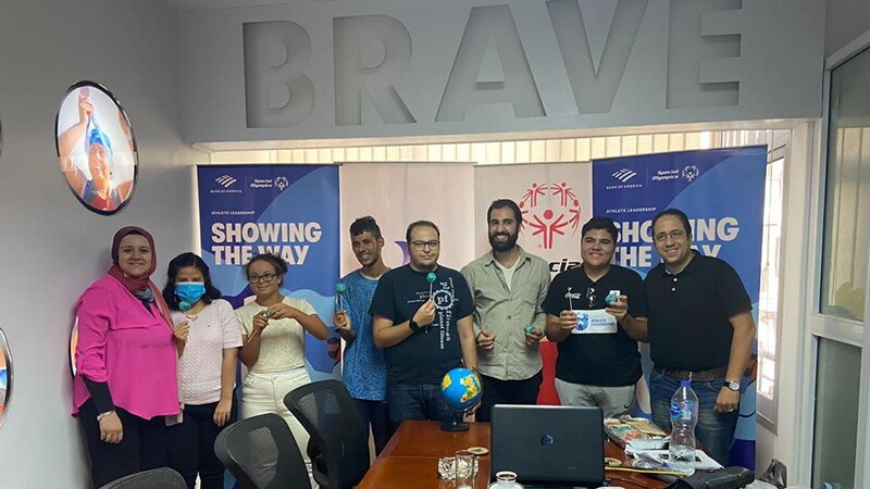 Group of nine people standing side by side. 