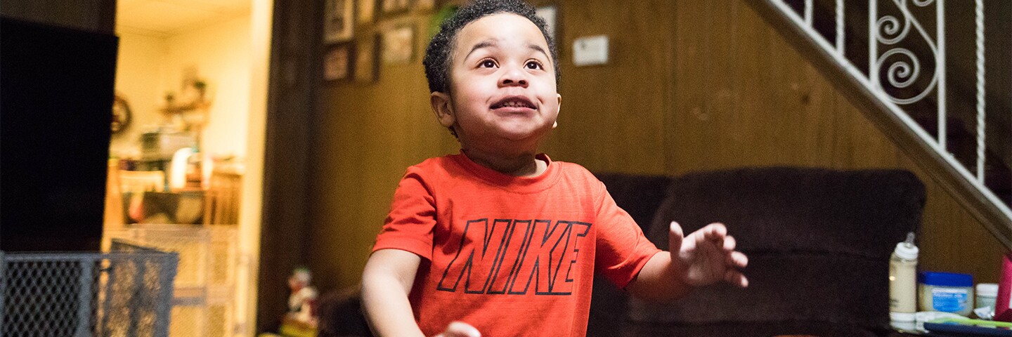 Young Boy walking through a living room.