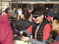 An Athlete Leader holding a brochure and smiling.