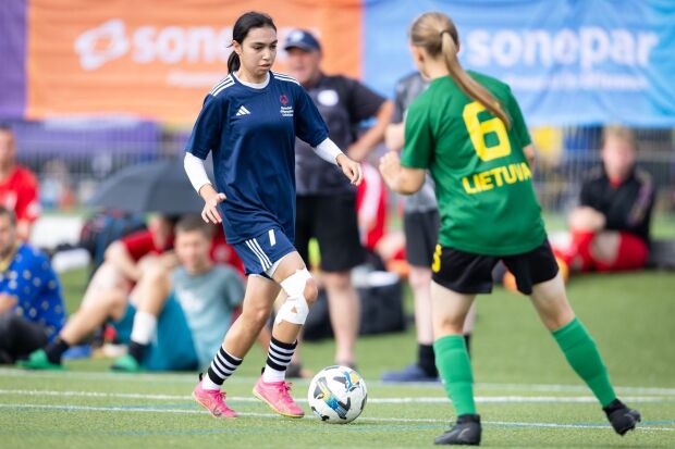 An athlete dribbling a football