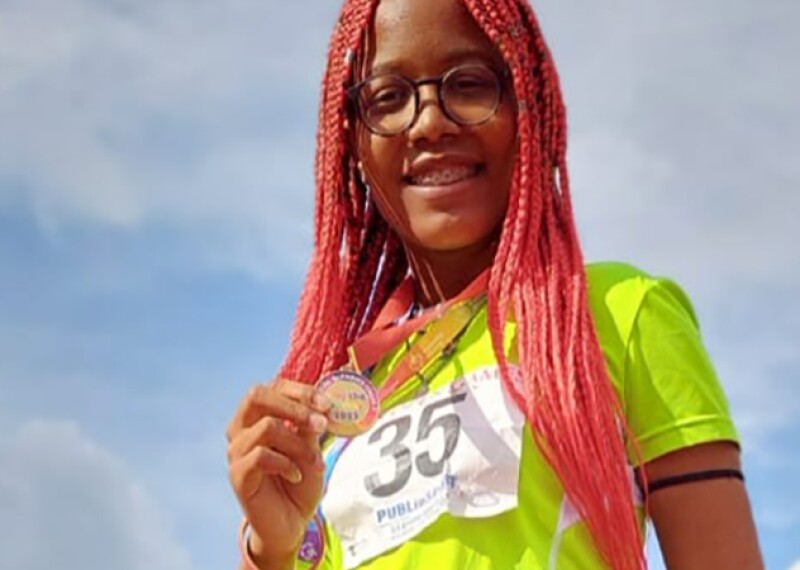 Athlete, Grace Enwereuzoh, proudly holding a medal.