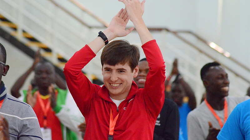 Soeren Palumbo at a game, clapping his hands above his head. 
