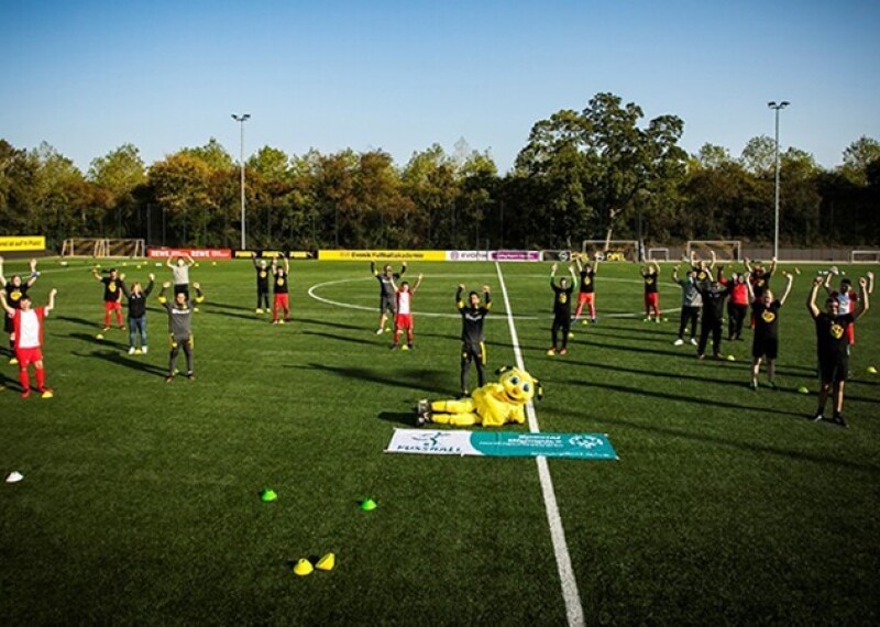 a team on the field spread out for a group photo