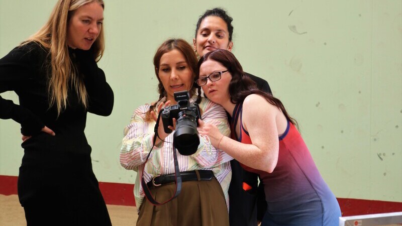 VOGUE team and model taking a look at the photos on a camera.