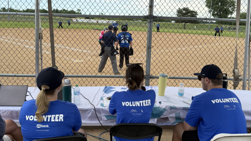 Volunteers watching a baseball game. 