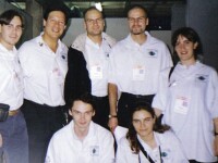 Seven people wearing white jerseys posing for the photo.