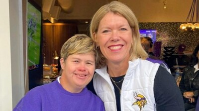 Two people stood side by side smiling