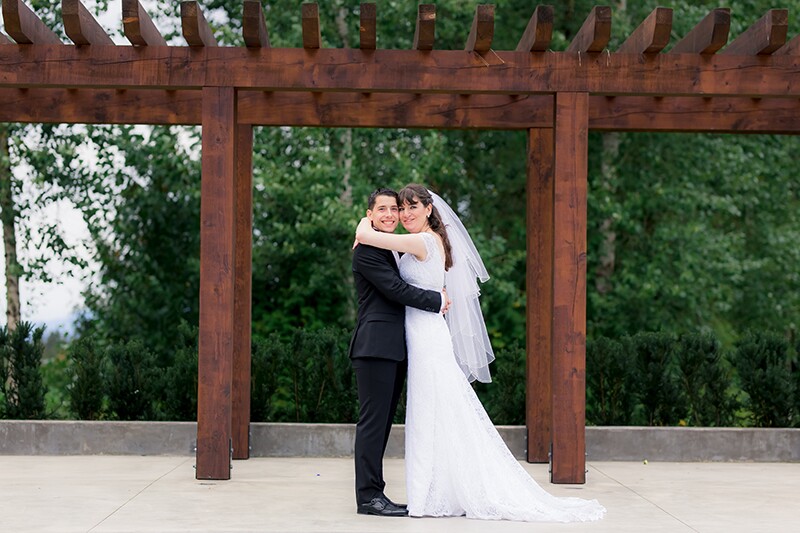 Crystal and Matthew's outside wedding photo, he's in a black tux she is in a white dress.