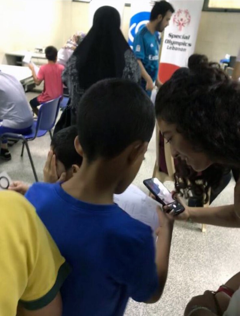 Young woman helping a young boy with work. 