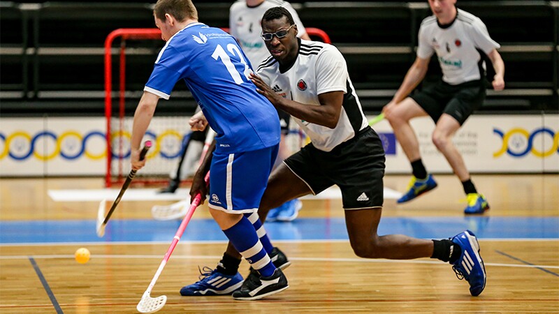 Floorball players in the middle of a game.