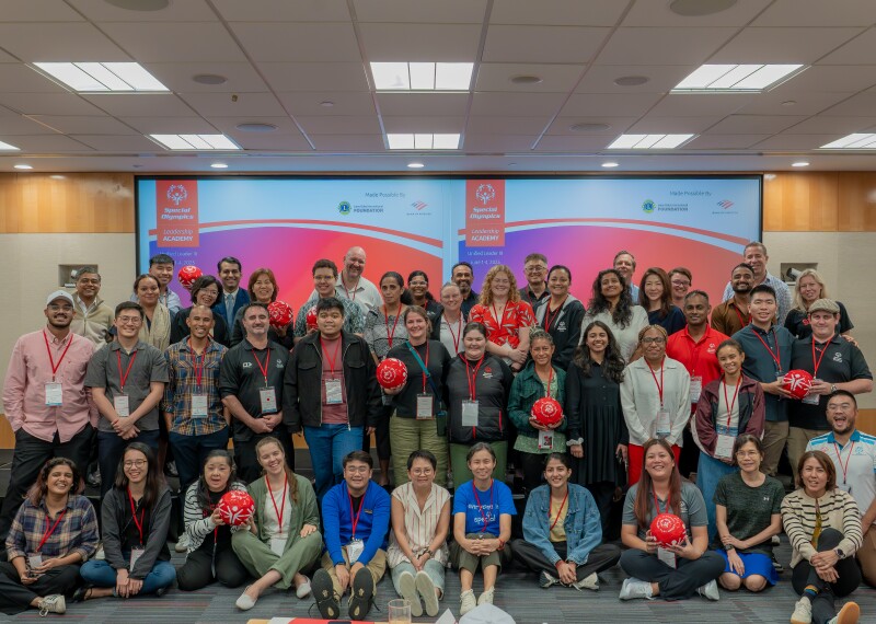 Large group of people standing in rows for a group photo. 
