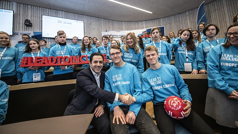 A group of young adults standing together in a large group at Special Olympics Youth Summit in Östersund 2020