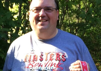 Rick holding his medals.