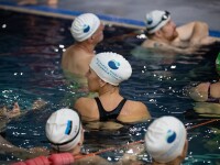 people in swim caps standing in pool