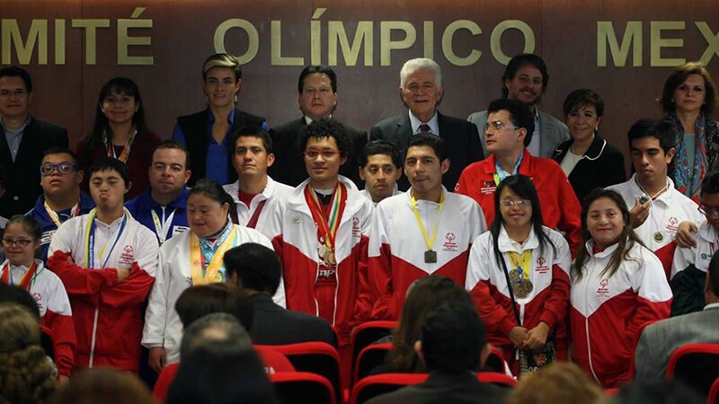Group of athletes and representatives standing together.