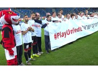 Israeli Hapoel Haifa team, a mascot, and Special Olympics athletes hold up a banner on the pitch before the championship football game starts. 