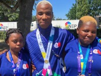 Three athletes standing side by side for a group photo. 