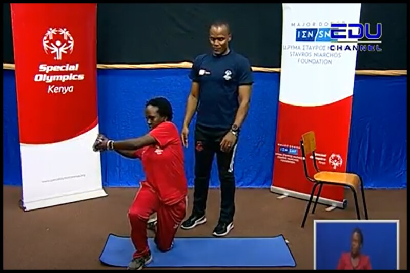 A photo from the EDU-TV broadcast of a Special Olympics coach Vincent Muigai advising athlete Shalel Tennah as she stretches her body.