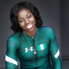 Professional photo of Seun Adigun in her Under Armor black, green, and white athletic suite.