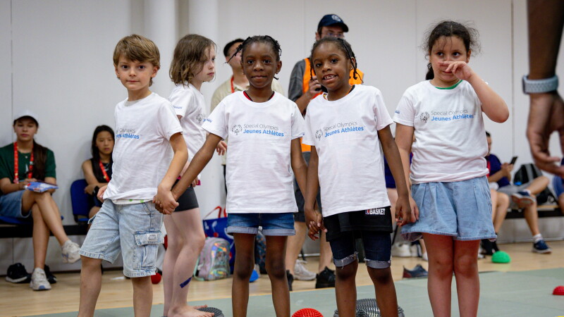 Young athletes holding hands for an exercise