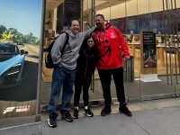 Three people standing in front of the Microsoft building. 