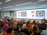 A conference announcement taking place in a room. 